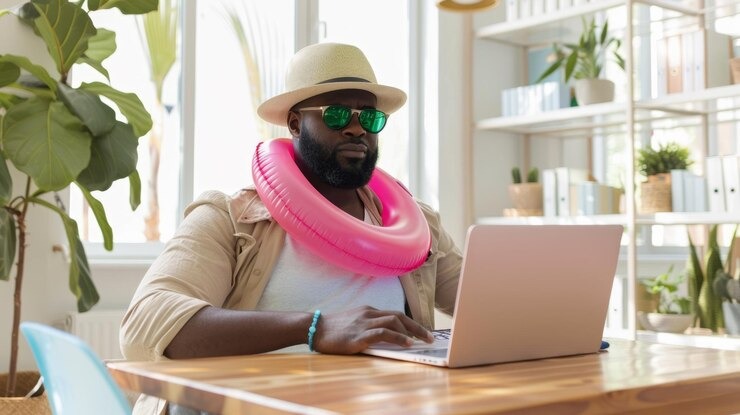 picture showing a man wearing a floater around his neck while doing remote work