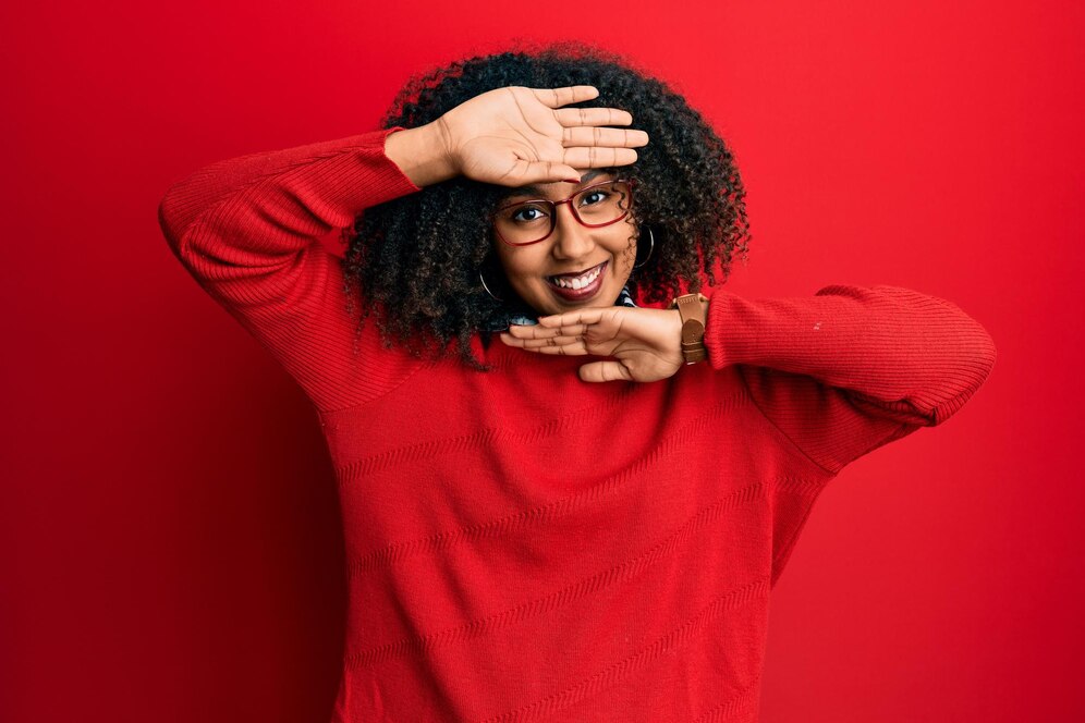 picture showing woman in red cardigan smiling